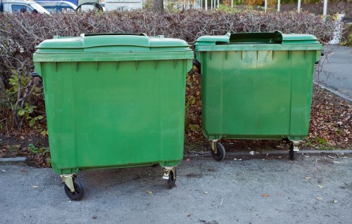 Truck and crew loading commercial waste at a storefront in Edmonton