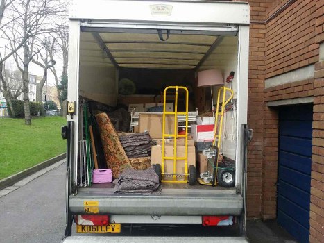 Man and van team loading debris at a busy Edmonton street