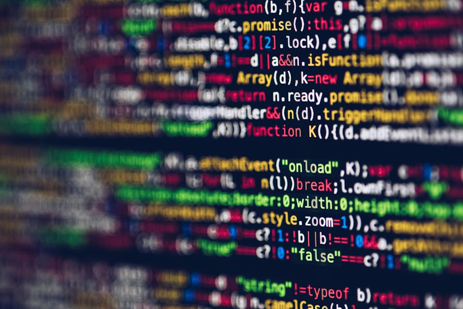 A close-up view of a computer screen displaying a colorful array of programming code in various languages, with syntax highlighting in red, green, blue, and yellow on a dark background. The code inclu